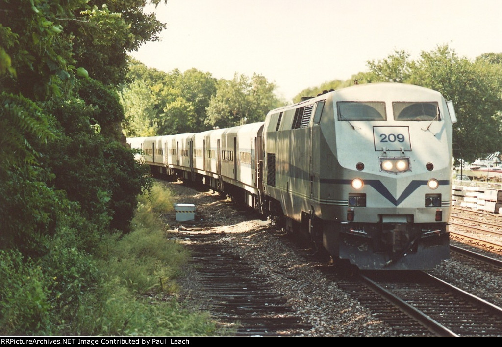 Outbound commuter approaches the station to makes its stop